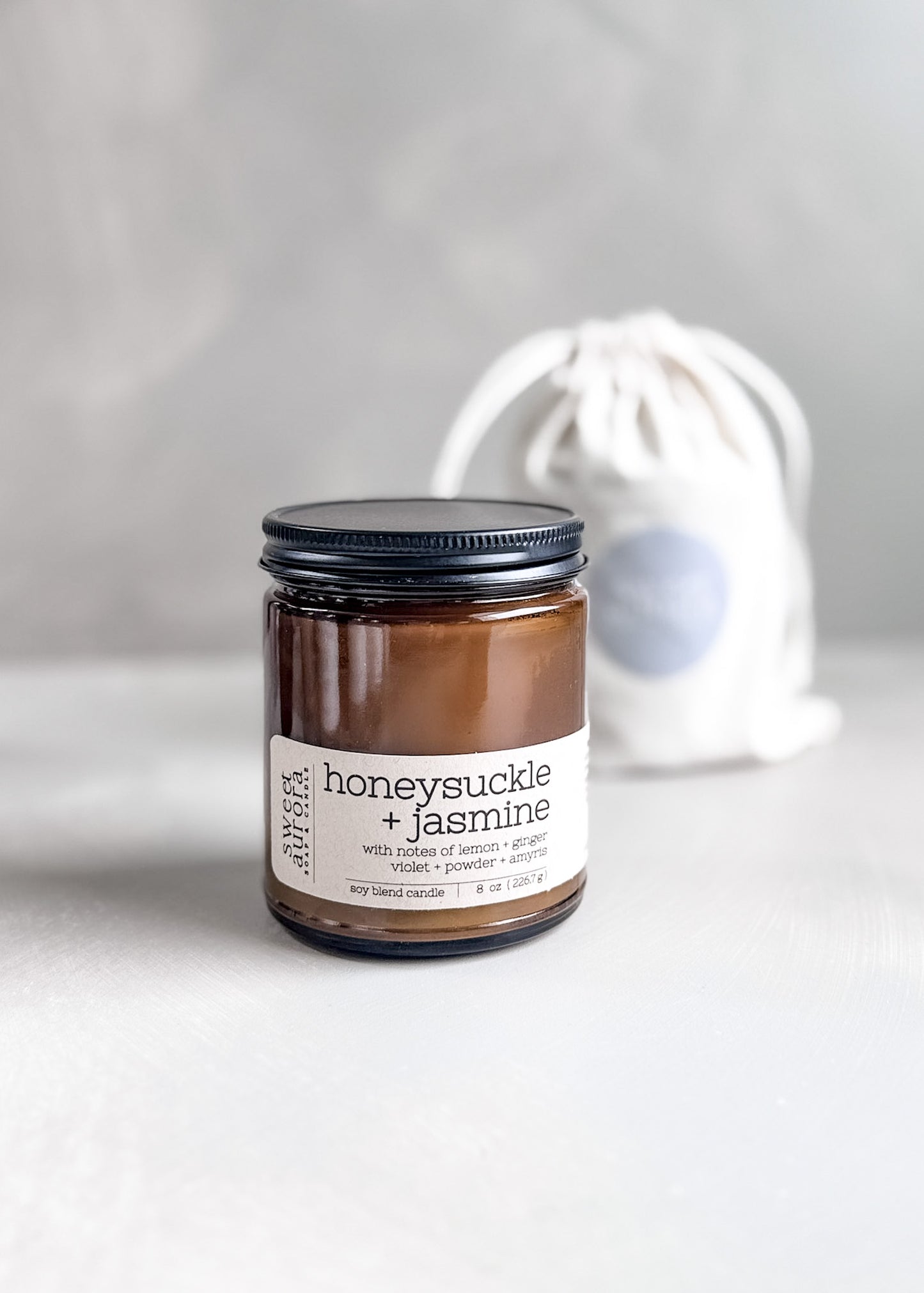 Honeysuckle Jasmine soy cotton wick candle in amber jar with branded gift bag