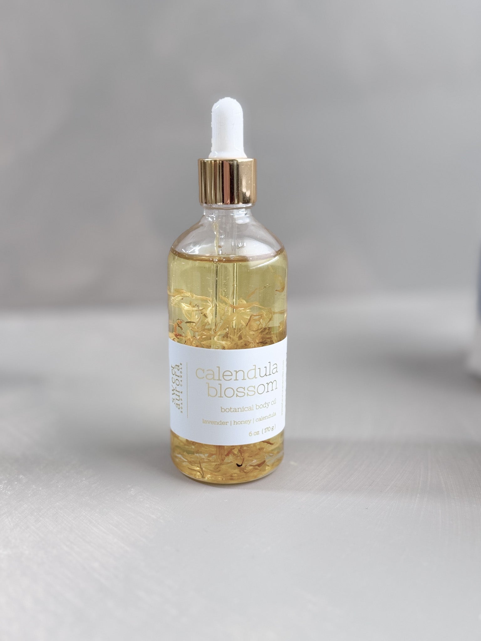 Bottle of calendula blossom body oil by Sweet Aurora