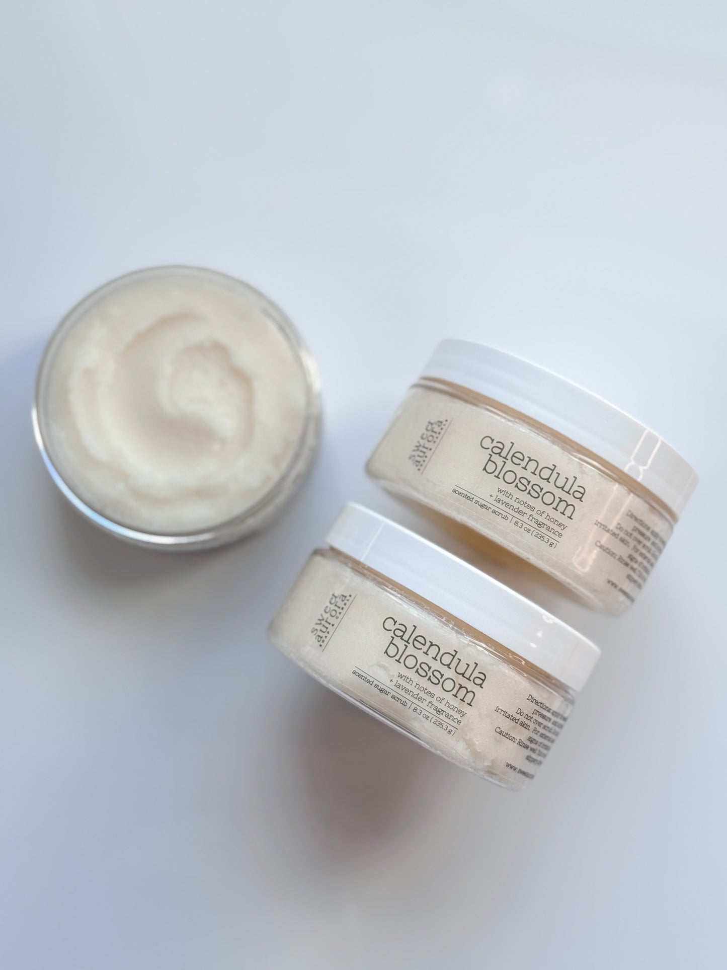 Calendula Blossom gentle exfoliating sugar scrub in jars