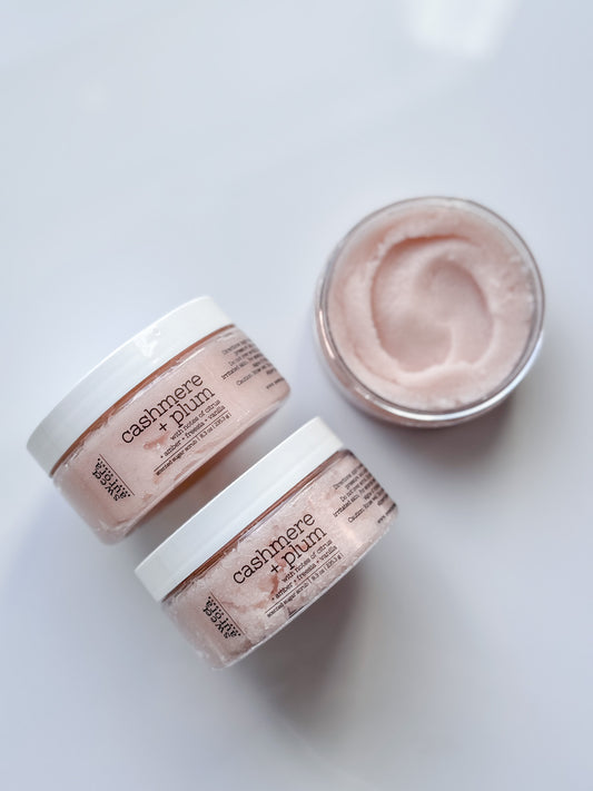 Cashmere + Plum gentle exfoliating sugar scrub jars with open jar showing texture