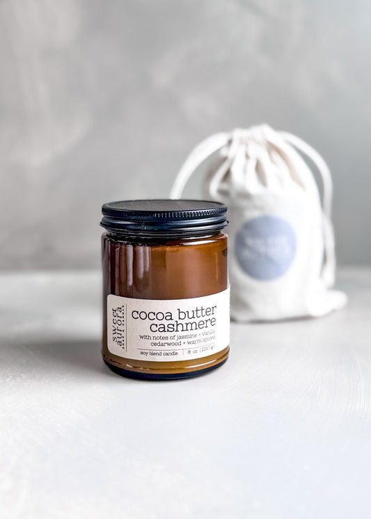 Cocoa Butter Cashmere soy cotton wick candle in amber jar with branded gift bag