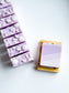Lavender + Amber purple shea butter soap bar on wooden soap dish