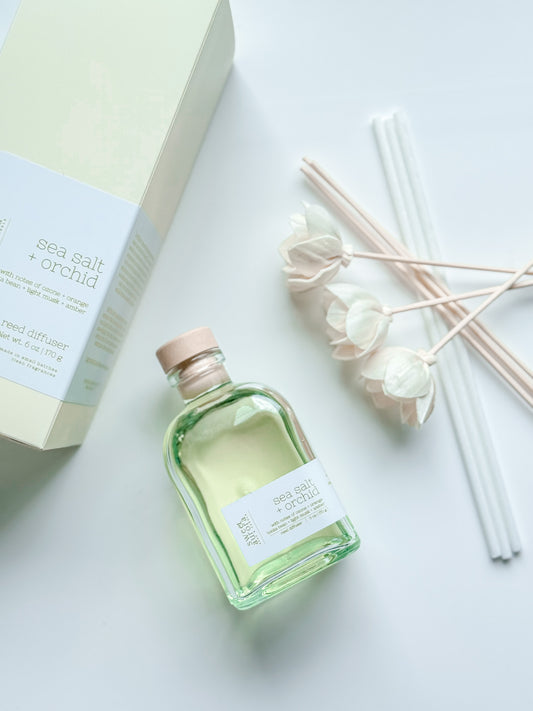 Sea Salt + Orchid reed diffuser bottle with decorative reeds and gift box